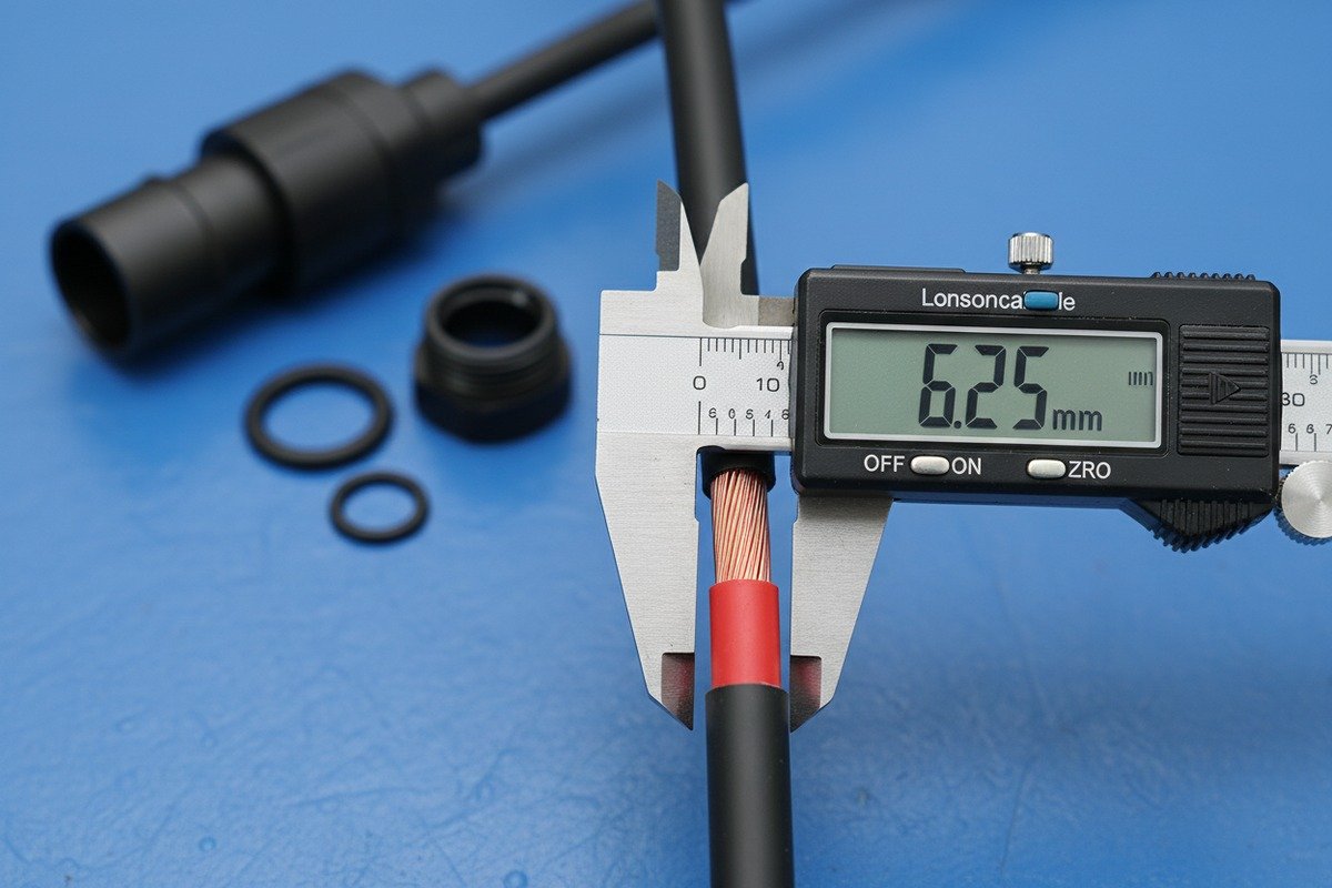 Measuring solar cable outer diameter with a digital caliper for MC4 waterproof gland fit. (ID#2)